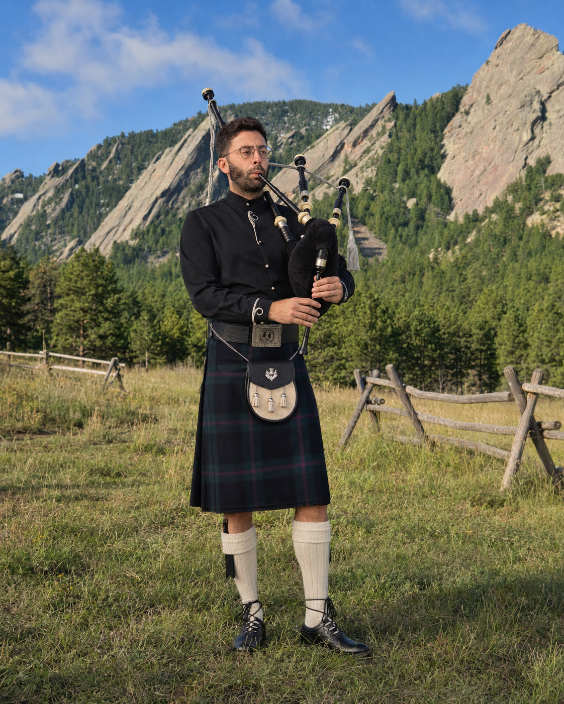 Zach Alley playing Highland bagpipes with the Flatirons in the background